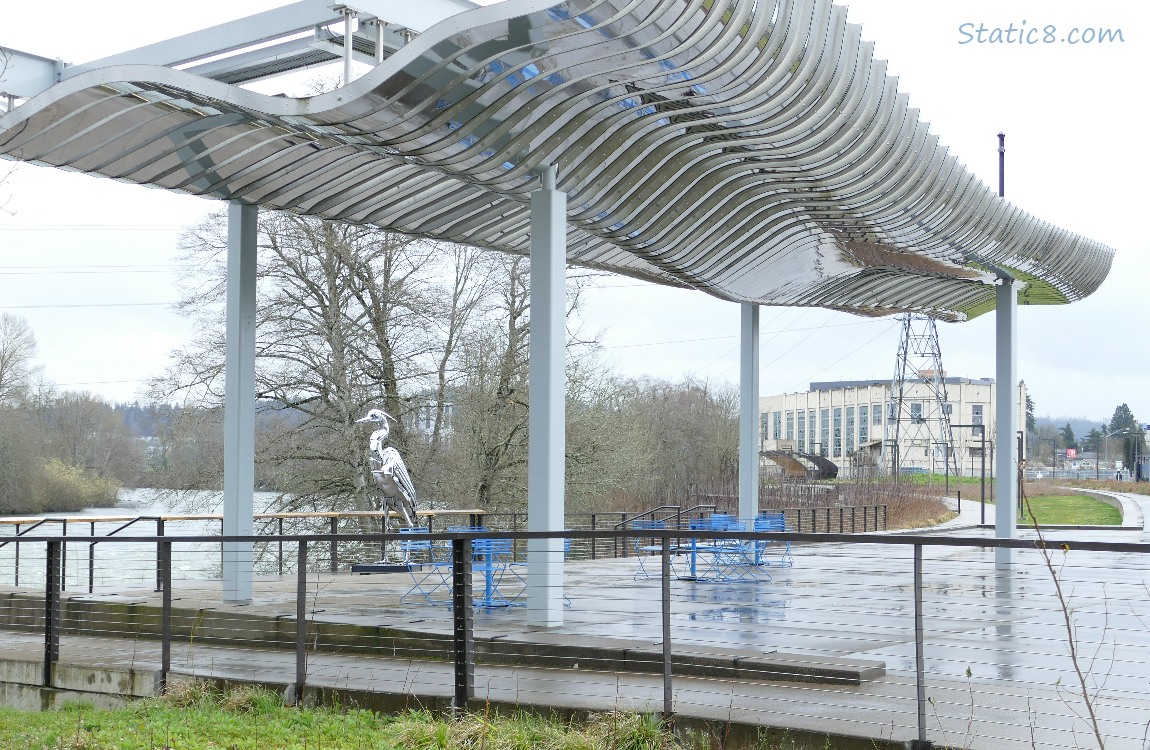 Art Pavilion with chrome Heron statue, the river in the background