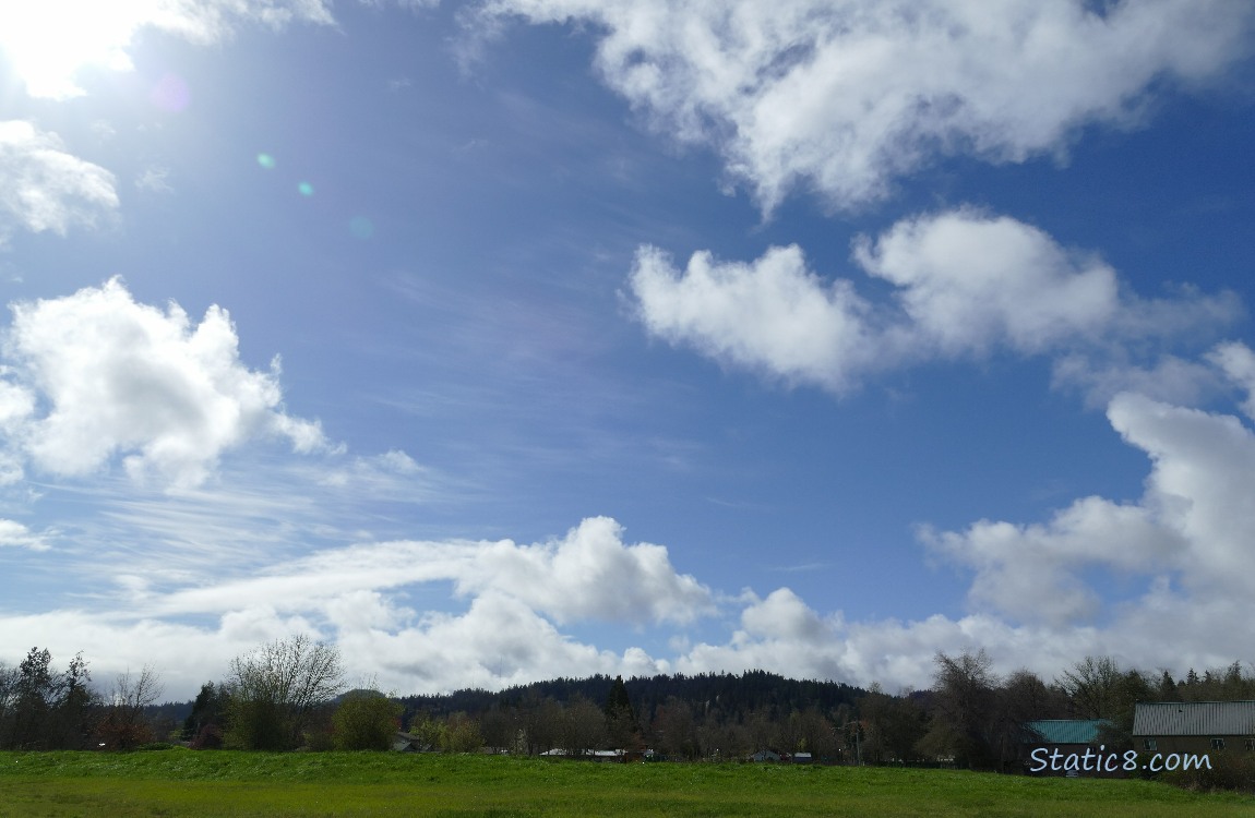 Blue sky with a few puffy white clouds