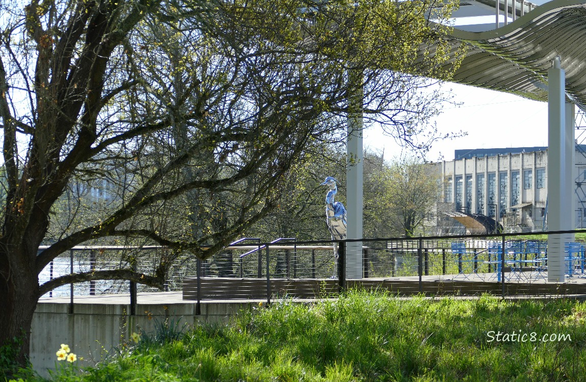 Art Pavilion with chrome sculpture of a heron, the river in the background