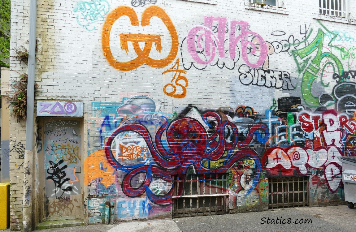 Graffiti on a wall, including a red and blue octopus