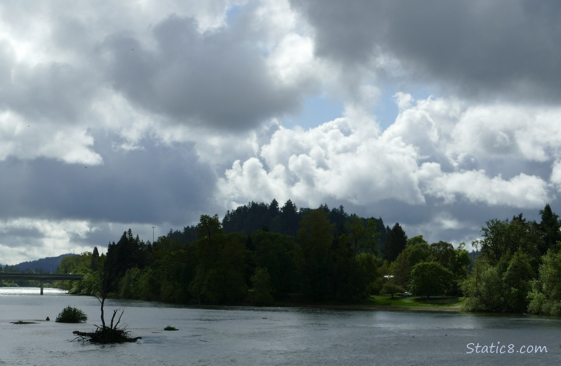 Clouds over the river and hill