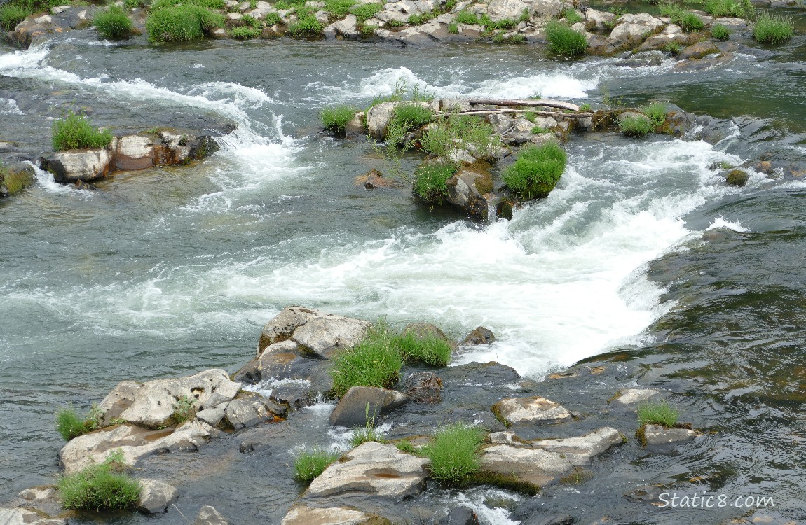 Looking down at the river flowing around rocks