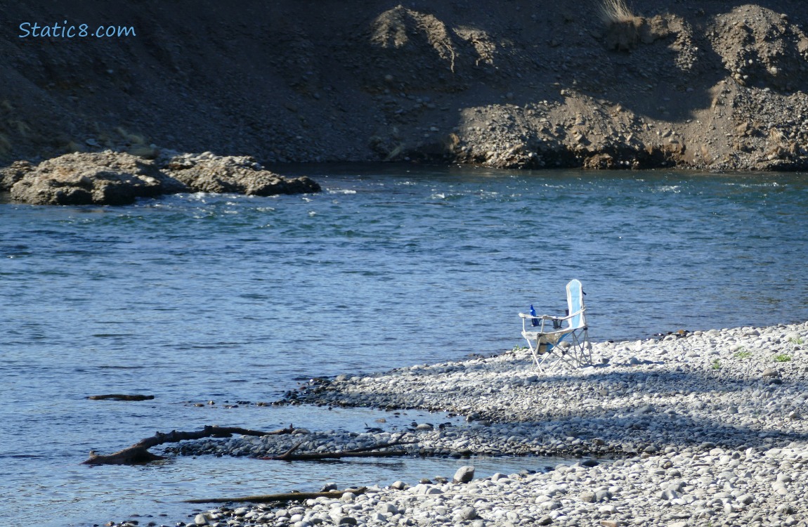 Folding chair on the bank of the river