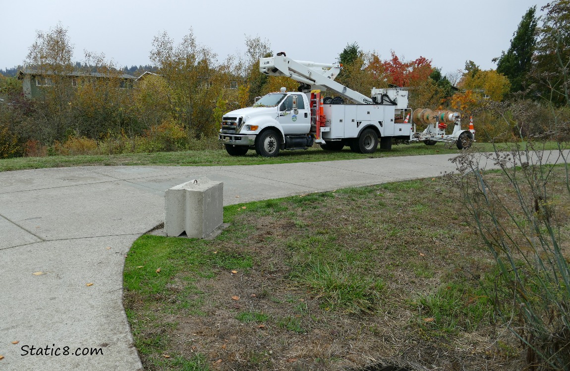 Work truck and a block next to the bike path