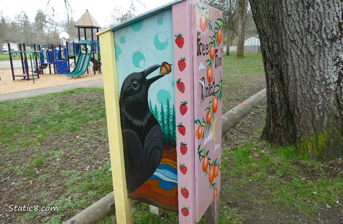 A Little Free Pantry with a crow painted on the side