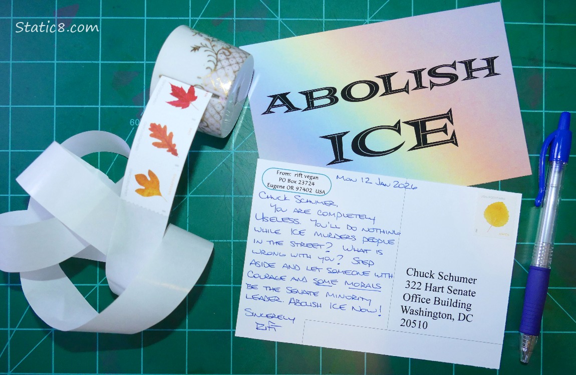 Abolish Ice postcards with postcard stamps and a pen
