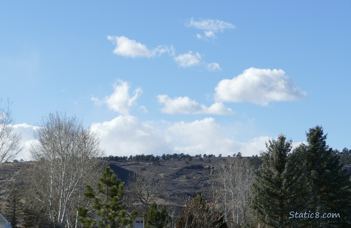 Small puffy clouds above a dry landscape