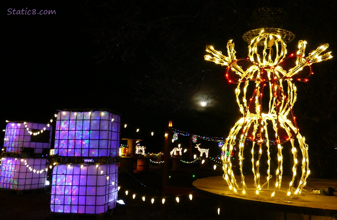 Snow person christmas lights with the moon in the sky