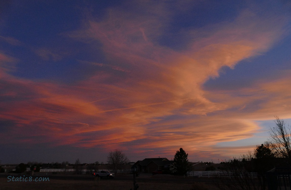 Cirrus clouds turned peach coloured with the sunset