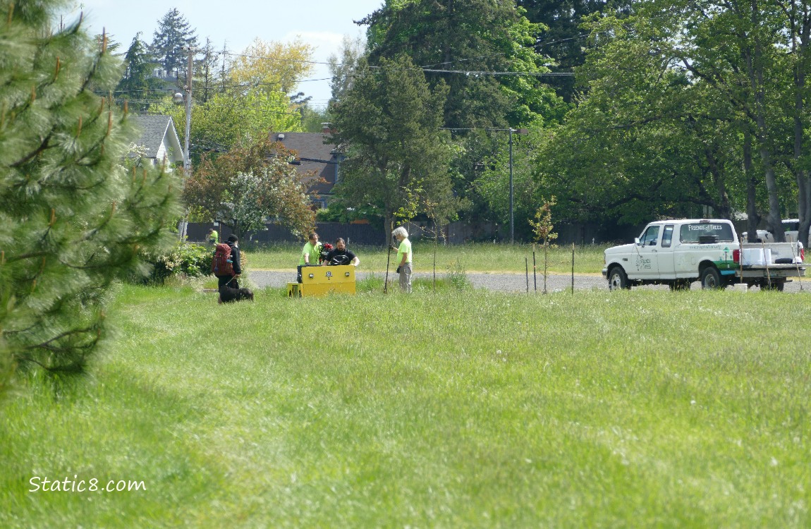 Men and a pickup in the distance