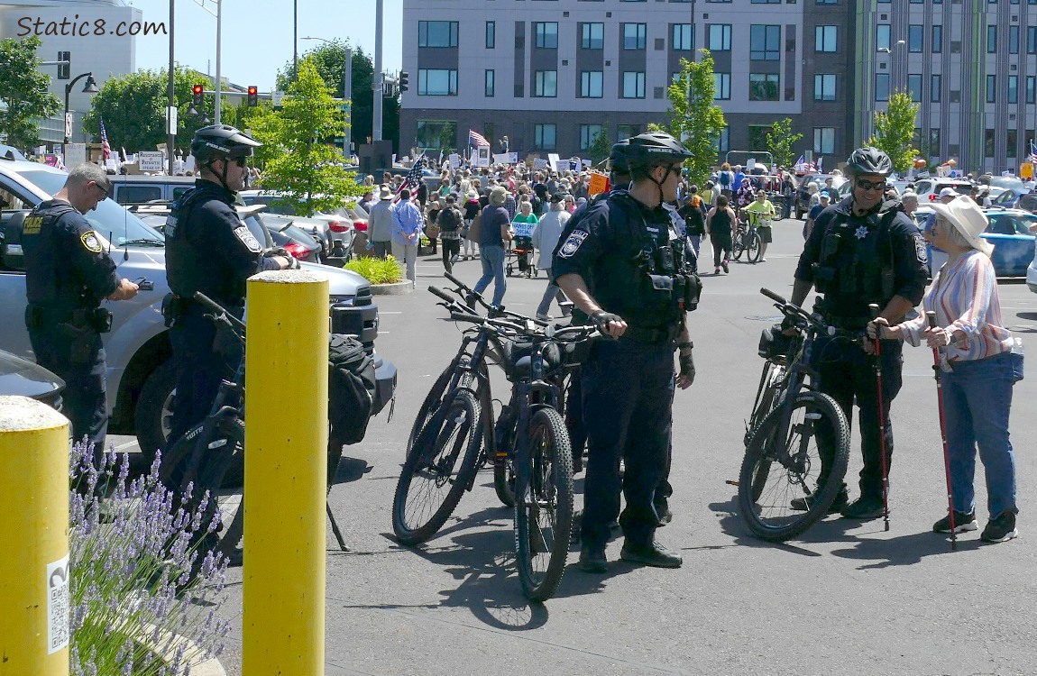 Five policemen with their bikes at the edge of the protest