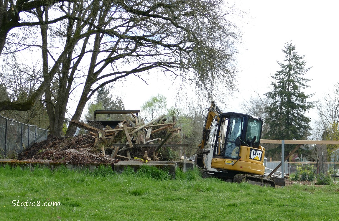 Machinery and a pile of old fence posts