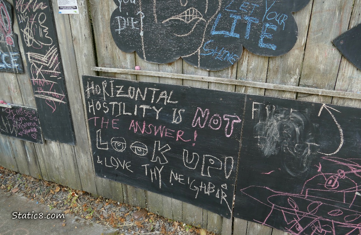 Chalk boards on a wood fence