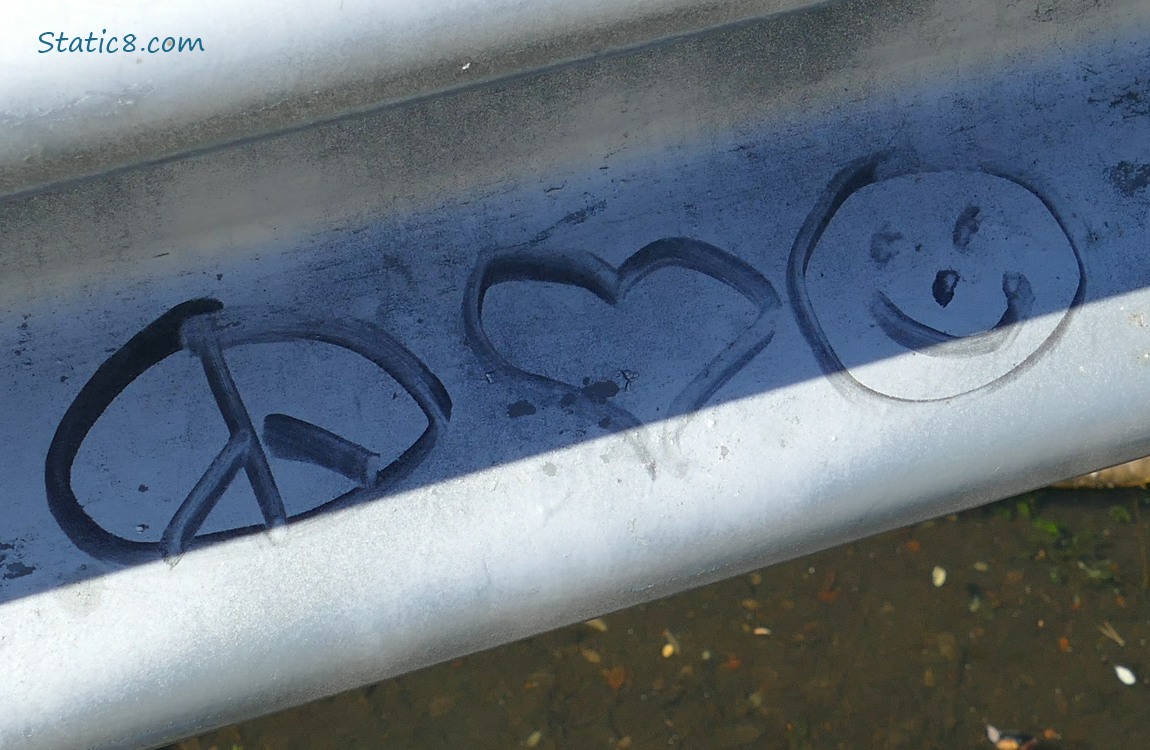 Peace sign, heart and smiley face graffiti