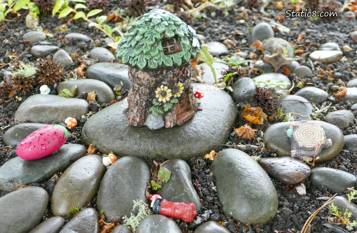 Fairy house surrounded by river rocks